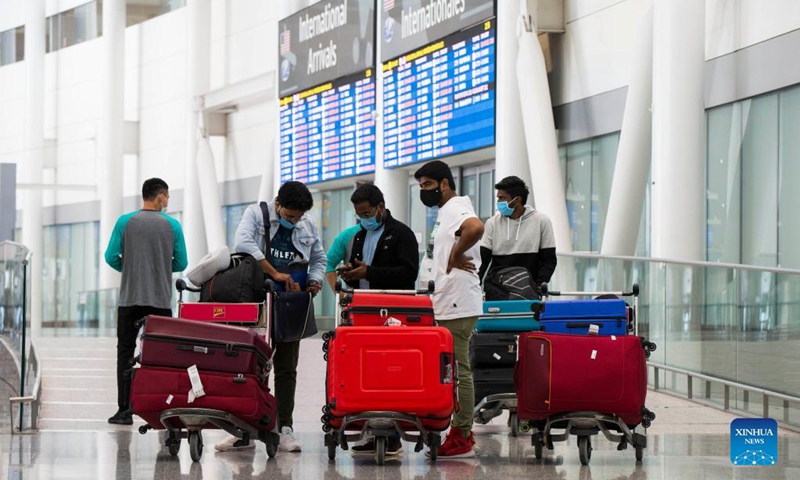 Travelers wearing face masks are seen at the arrivals hall of Toronto Pearson International Airport in Mississauga, Ontario, Canada, on Sept. 7, 2021. Canada began Tuesday to allow entry for fully vaccinated foreigners who have had a full course of a Health Canada-approved COVID-19 vaccine. (Photo by Zou Zheng/Xinhua)