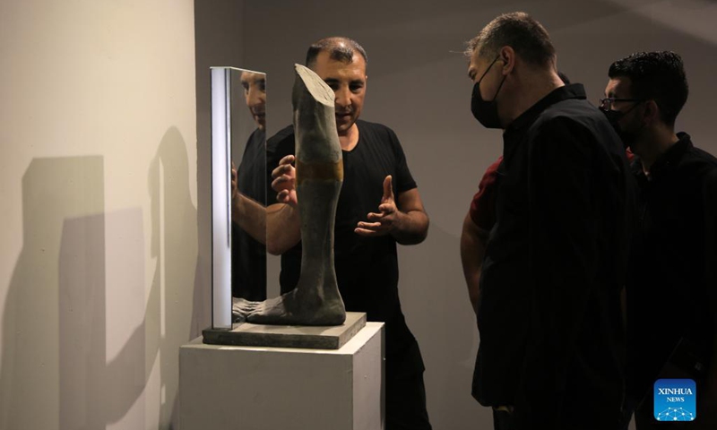 People visit an art exhibition at a contemporary art center in Gaza City, on Sept. 6, 2021. The artist depicted through his sculptures young Palestinians who lost their limbs during the wars and conflicts with Israel and the Great March of Return in the Gaza Strip.(Photo: Xinhua)