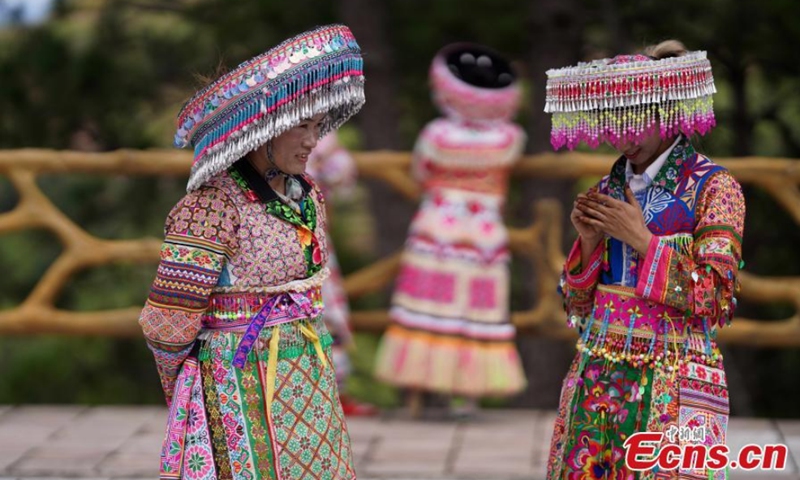 Miao women dance Gameng Kadou at a square in Yongping, Southwest China's Yunnan Province, Sept. 7, 2021. Gameng Kadou, the dance with a history of more than 1,800 years, is a transliteration of the Miao language. The music accompanied by Lusheng, a reed-pipe wind instrument, comes from the original music elements of the Miao people. Photo: CNSphoto
