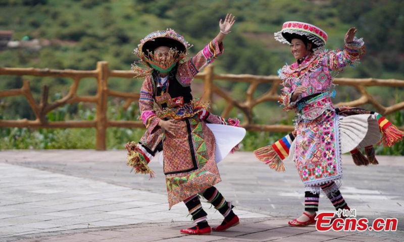 Miao women dance Gameng Kadou at a square in Yongping, Southwest China's Yunnan Province, Sept. 7, 2021. Gameng Kadou, the dance with a history of more than 1,800 years, is a transliteration of the Miao language. The music accompanied by Lusheng, a reed-pipe wind instrument, comes from the original music elements of the Miao people. Photo: CNSphoto