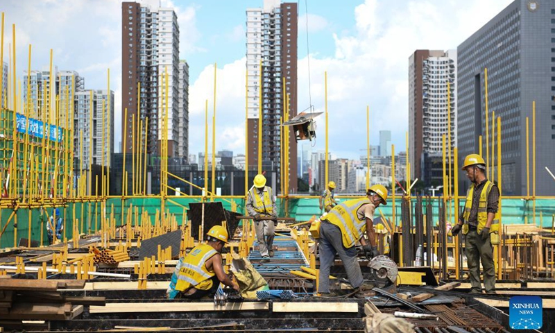 Workers operate at the construction site for a transaction center in Qianhai, Shenzhen City, south China's Guangdong Province, on Sept. 8, 2021.Photo:Xinhua
