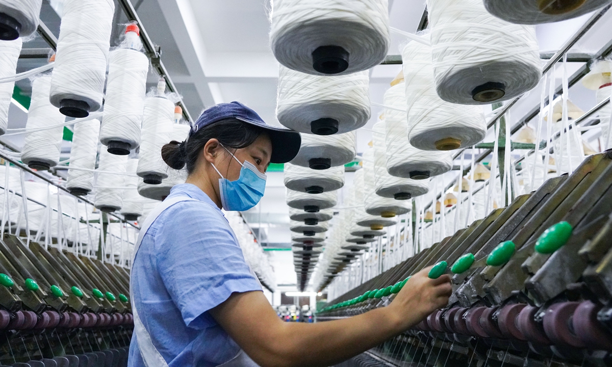 A new material firm in Haian, East China's Jiangsu Province, steps up production for foreign orders. Their products are mainly used in overseas markets for seat covers and passenger vehicle fabric. Photo: cnsphoto