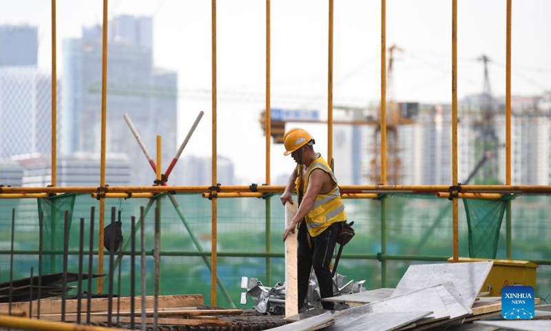 A worker operates at the construction site for a transaction center in Qianhai, Shenzhen City, south China's Guangdong Province, on Sept. 8, 2021.Photo:Xinhua