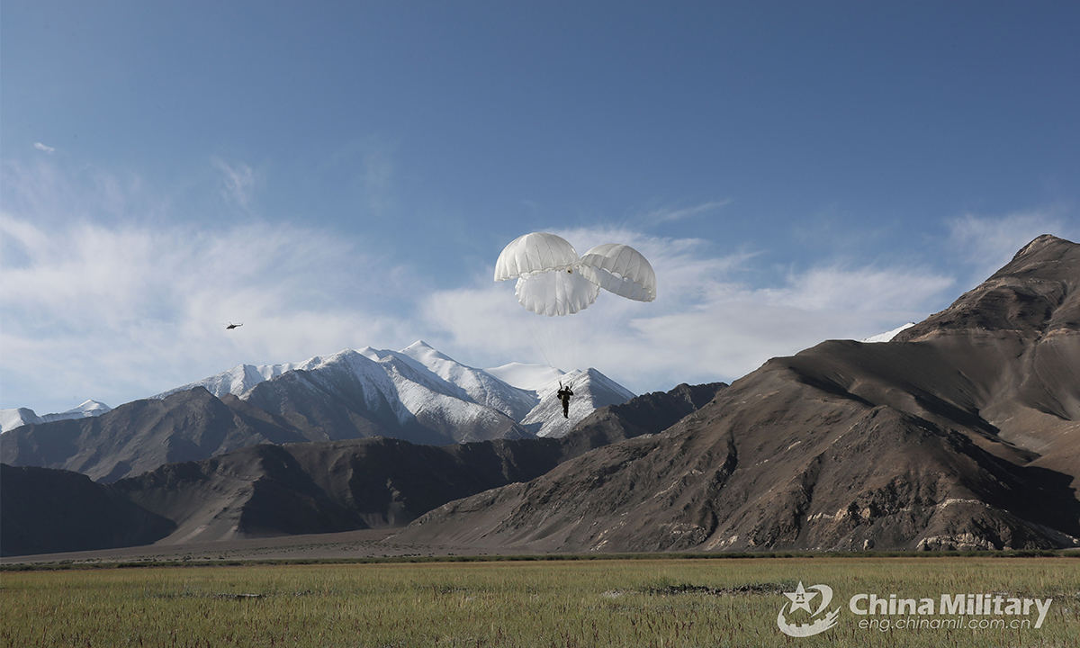 A paratrooper assigned to a special operations brigade under the PLA Xinjiang Military Command controls his parachute to reach the drop zone during a parachuting training exercise on August 31, 2021. This exercise effectively beefed up the troops' operation skills in plateau area. (eng.chinamil.com.cn/Photo by Shan Chuangyang) 