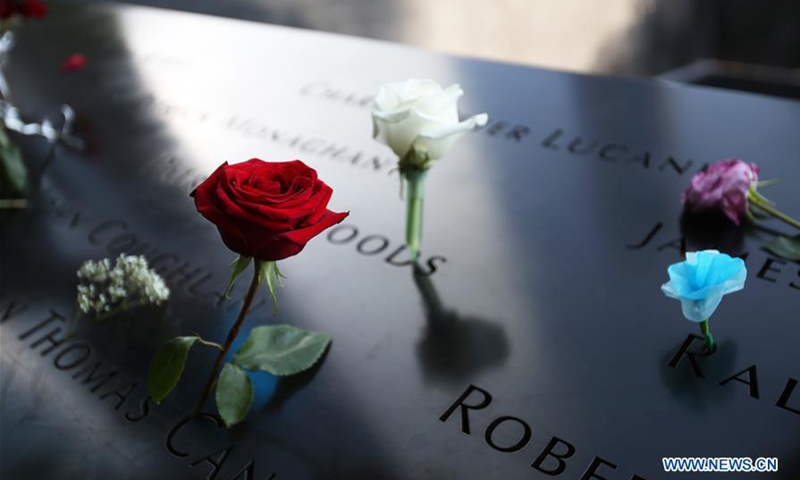 Flowers are placed to mourn the victims of the 9/11 terror attacks at the National September 11 Memorial and Museum in New York, the United States, September 11, 2019.Photo: Xinhua