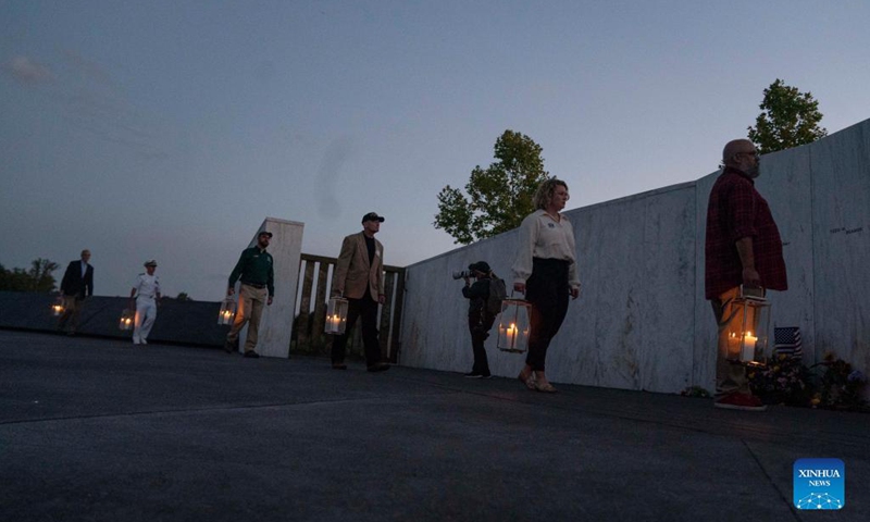 People place lanterns at the Wall of Names during a candlelight memorial to the passengers and crew of United Airlines Flight 93 in Shanksville, Pennsylvania, the United States, Sept. 10, 2021. Memorials were held at the Flight 93 National Memorial in Pennsylvania to mark the 20th anniversary of the Sept. 11 attacks.(Photo: Xinhua)