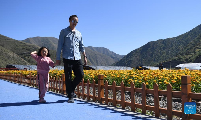 Tourists visit a flower farm in Lisai Village of Zho'nyin County in Gannan, northwest China's Gansu Province, Sept. 11, 2021. In recent years, the local government of Lisai Village has taken advantage of the natural resources to develop rural tourism and helped increase villagers' income. Photo: Xinhua