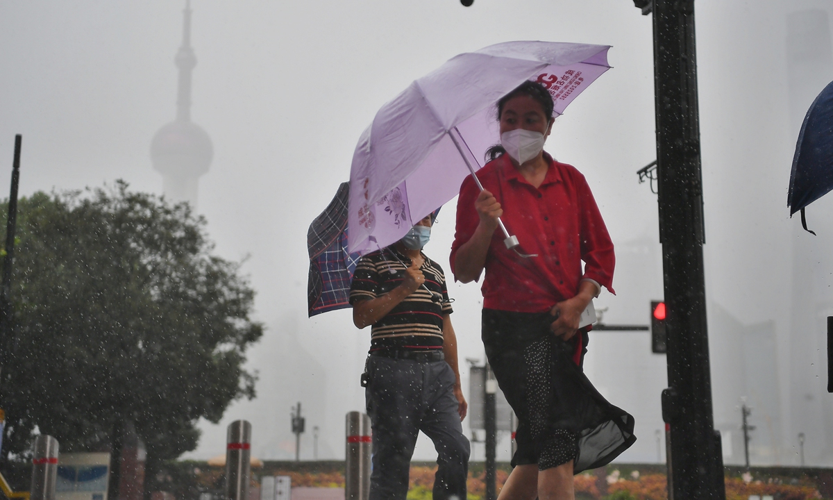 Residents in Shanghai hold umbrellas as they walk in the rain on Sunday under the impact of Typhoon Chanthu. East China's Zhejiang Province and Shanghai issued alerts and suspended schools for the storm, which is expected to make landfall in the two areas on September 13. Photo: VCG