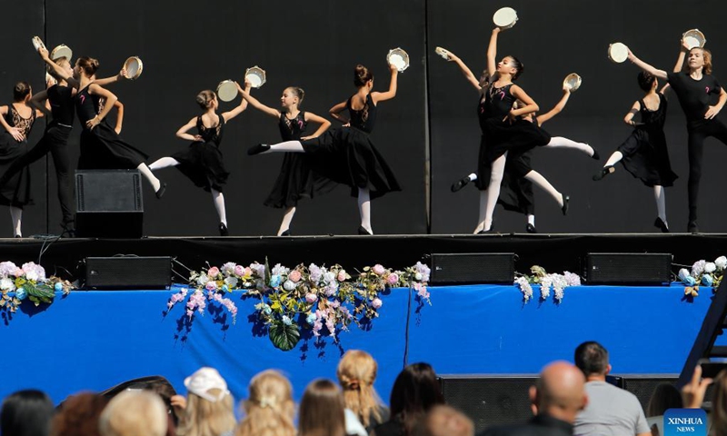 Ballet students perform on a stage in front of Bucharest's National Opera hall during the Dance Gala project - childhood in dance steps, in downtown Bucharest, Romania, Sept. 12, 2021.Photo: Xinhua
