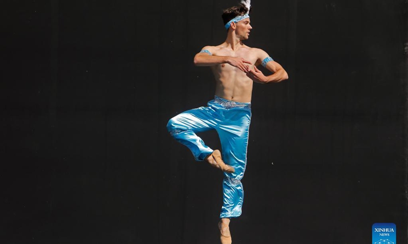 A ballet student perform on a stage in front of Bucharest's National Opera hall during the Dance Gala project - childhood in dance steps, in downtown Bucharest, Romania, Sept. 12, 2021.Photo: Xinhua