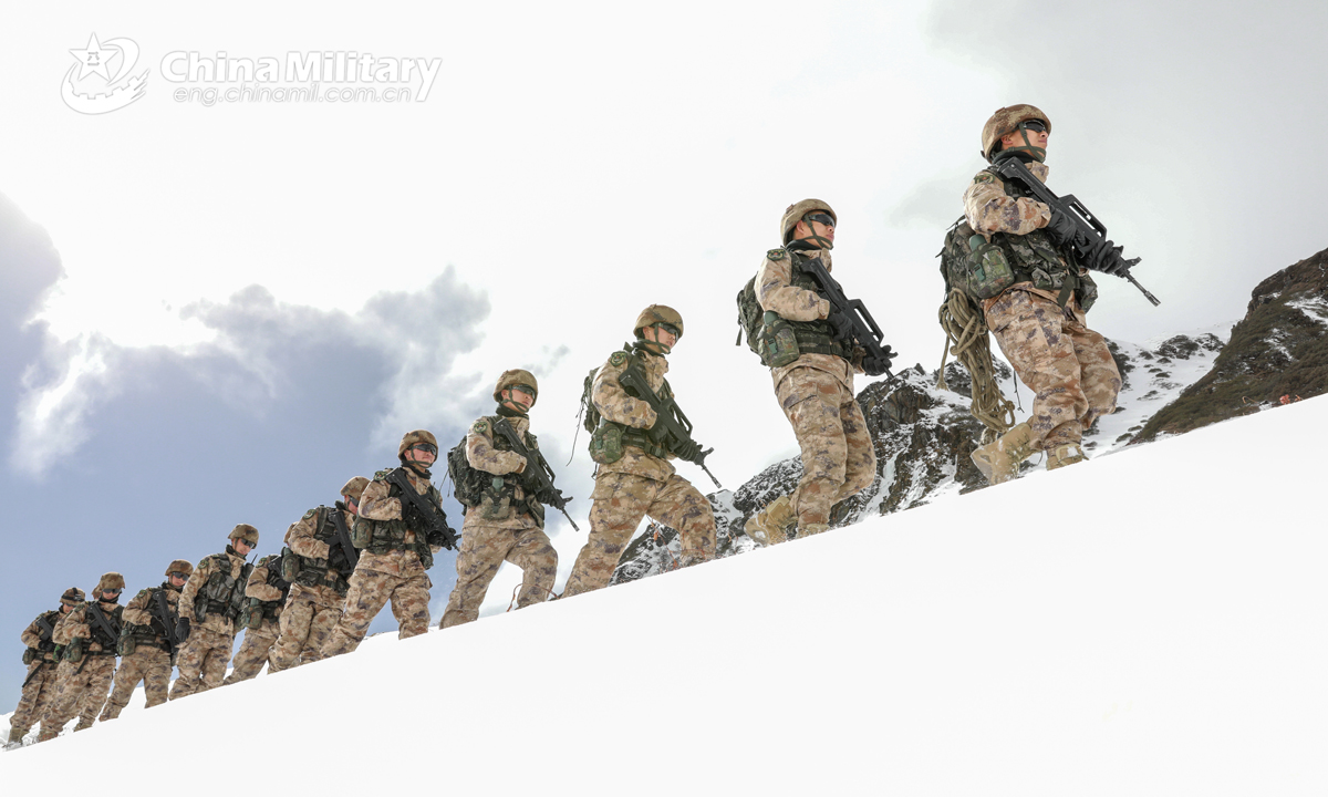 Frontier defense soldiers assigned to a border defense regiment with the Shannan Military Sub-command under the PLA Tibet Military Command patrol the snow-blanketed border at the elevation of over 5,000 meters in Tibet Autonomous Region on January 23, 2021. (eng.chinamil.com.cn/Photo by Zhang Zhaojie)