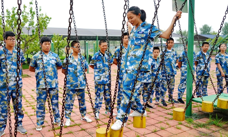 Students train on hanging piles at a National Defense Education and Training Center in Qian'an city, North China's Hebei province.File Photo: Xinhua