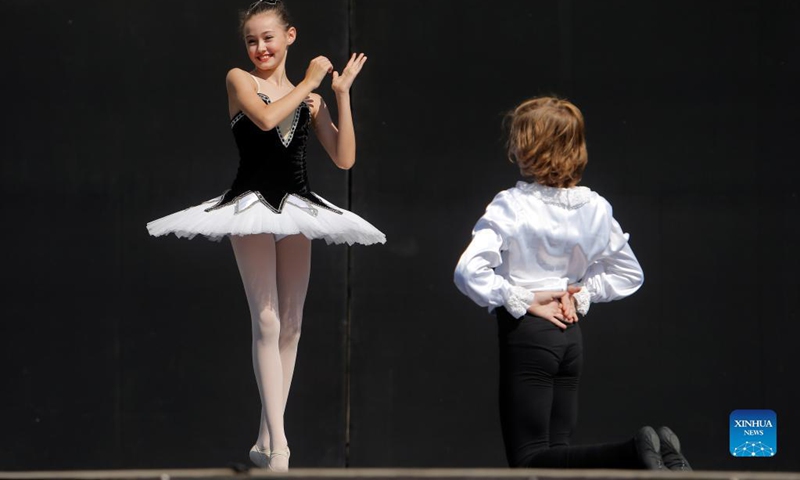 Ballet students perform on a stage in front of Bucharest's National Opera hall during the Dance Gala project - childhood in dance steps, in downtown Bucharest, Romania, Sept. 12, 2021.Photo: Xinhua