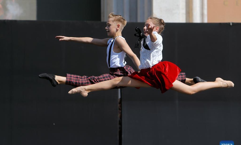 Ballet students perform on a stage in front of Bucharest's National Opera hall during the Dance Gala project - childhood in dance steps, in downtown Bucharest, Romania, Sept. 12, 2021.Photo: Xinhua