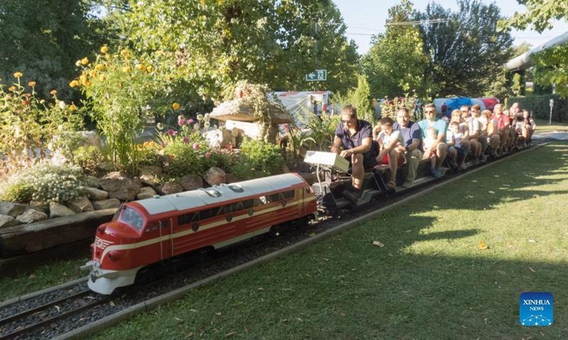 People ride on miniature train carriages at the Garden Railway Festival held in Hungarian Railway Museum in Budapest, Hungary on Sept. 12, 2021.Photo: Xinhua