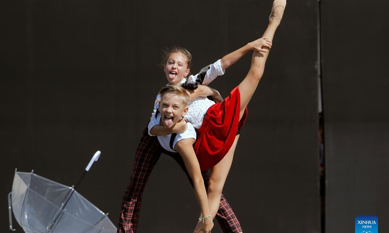 Ballet students perform on a stage in front of Bucharest's National Opera hall during the Dance Gala project - childhood in dance steps, in downtown Bucharest, Romania, Sept. 12, 2021.Photo: Xinhua
