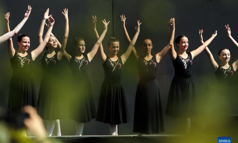 Ballet students perform on a stage in front of Bucharest's National Opera hall during the Dance Gala project - childhood in dance steps, in downtown Bucharest, Romania, Sept. 12, 2021.Photo: Xinhua