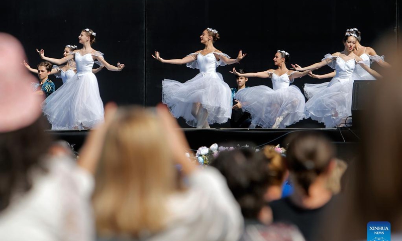 Ballet students perform on a stage in front of Bucharest's National Opera hall during the Dance Gala project - childhood in dance steps, in downtown Bucharest, Romania, Sept. 12, 2021.Photo: Xinhua