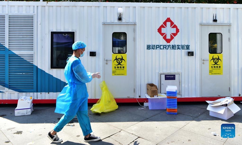 A staff member walks past a PCR (polymerase chain reaction) lab for nucleic acid testing in Xianyou County, southeast China's Fujian Province, Sept. 14, 2021. Three PCR labs have been built in the county to boost nucleic acid detection capacity.Photo:Xinhua
