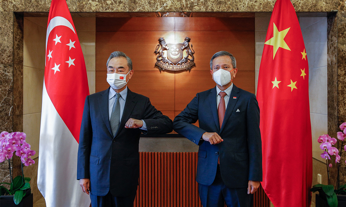 Chinese State Councilor and Foreign Minister Wang Yi (left) bumps elbows with Singaporean Foreign Minister Vivian Balakrishnan during Wang's visit to the country on Monday. Photo: AFP