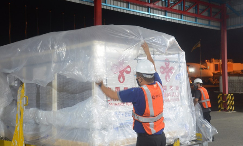 Workers unload a batch of Sinopharm COVID-19 vaccines at Brunei International Airport, Brunei, Sept. 12, 2021.(Photo: Xinhua)