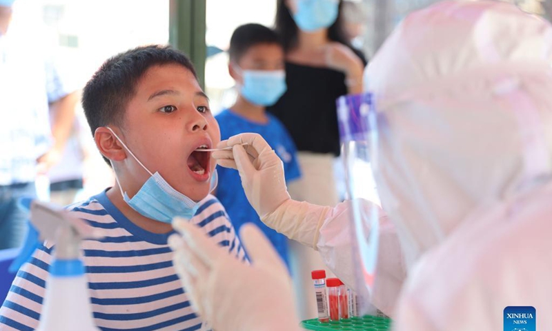 A medical worker collects a swab sample for nucleic acid testing at a testing site in a community in Siming District, Xiamen, southeast China's Fujian Province, Sept. 14, 2021. Xiamen, a port city in Fujian Province, has started a citywide nucleic acid testing due to the latest COVID-19 resurgence in the city, authorities said Tuesday.Photo:Xinhua