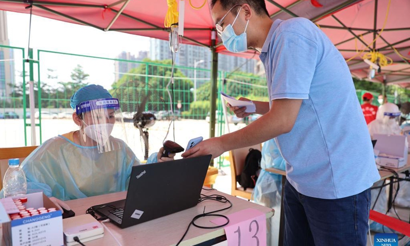 A resident registers for nucleic acid testing at a testing site in a community in Siming District, Xiamen, southeast China's Fujian Province, Sept. 14, 2021. Xiamen, a port city in Fujian Province, has started a citywide nucleic acid testing due to the latest COVID-19 resurgence in the city, authorities said Tuesday.Photo:Xinhua