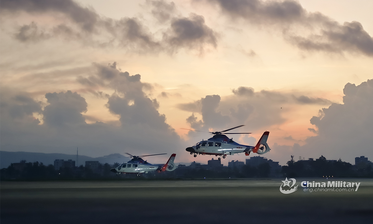 Two helicopters attached to a naval aviation regiment under the PLA Northern Theater Command take off for a search and rescue training exercise on August 24, 2021. (eng.chinamil.com.cn/Photo by Zhu Xuzhuo)

 