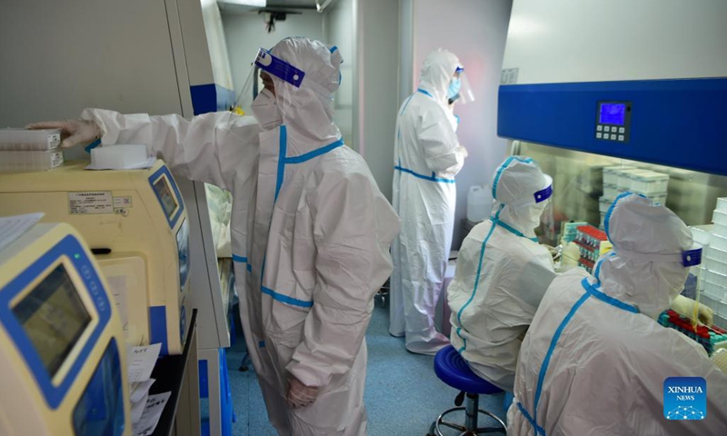 Staff members deal with nucleic acid testing samples in a PCR (polymerase chain reaction) lab in Xianyou County, southeast China's Fujian Province, Sept. 14, 2021. Three PCR labs have been built in the county to boost nucleic acid detection capacity.Photo:Xinhua