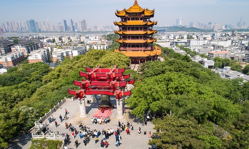 In this aerial photo taken on April 29, 2020, representatives of frontline health workers fighting COVID-19 attend a bell-ringing ceremony at the Yellow Crane Tower, or Huanghelou, a landmark in Wuhan, central China's Hubei Province. (Xinhua/Xiao Yijiu)