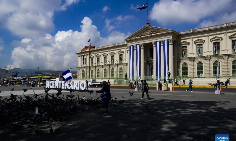 People walk by the Gerardo Barrios square decorated in celebration of the Bicentennial of Independence in front of the National Palace, at downtown of San Salvador, El Salvador, on Sept. 14, 2021. El Salvador, Guatemala, Honduras, Nicaragua and Costa Rica commemorated the Bicentennial of Independence of Central America on Sept. 15. Photo: Xinhua 