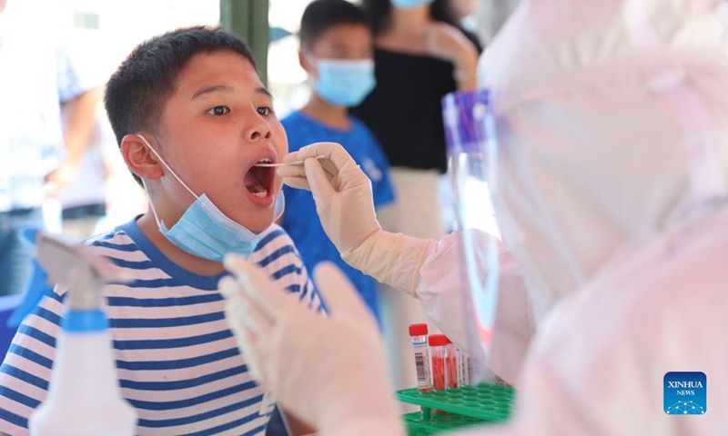 A medical worker collects a swab sample for nucleic acid testing at a testing site in a community in Siming District, Xiamen, southeast China's Fujian Province, Sept. 14, 2021. Xiamen, a port city in Fujian Province, has started a citywide nucleic acid testing due to the latest COVID-19 resurgence in the city, authorities said Tuesday. 