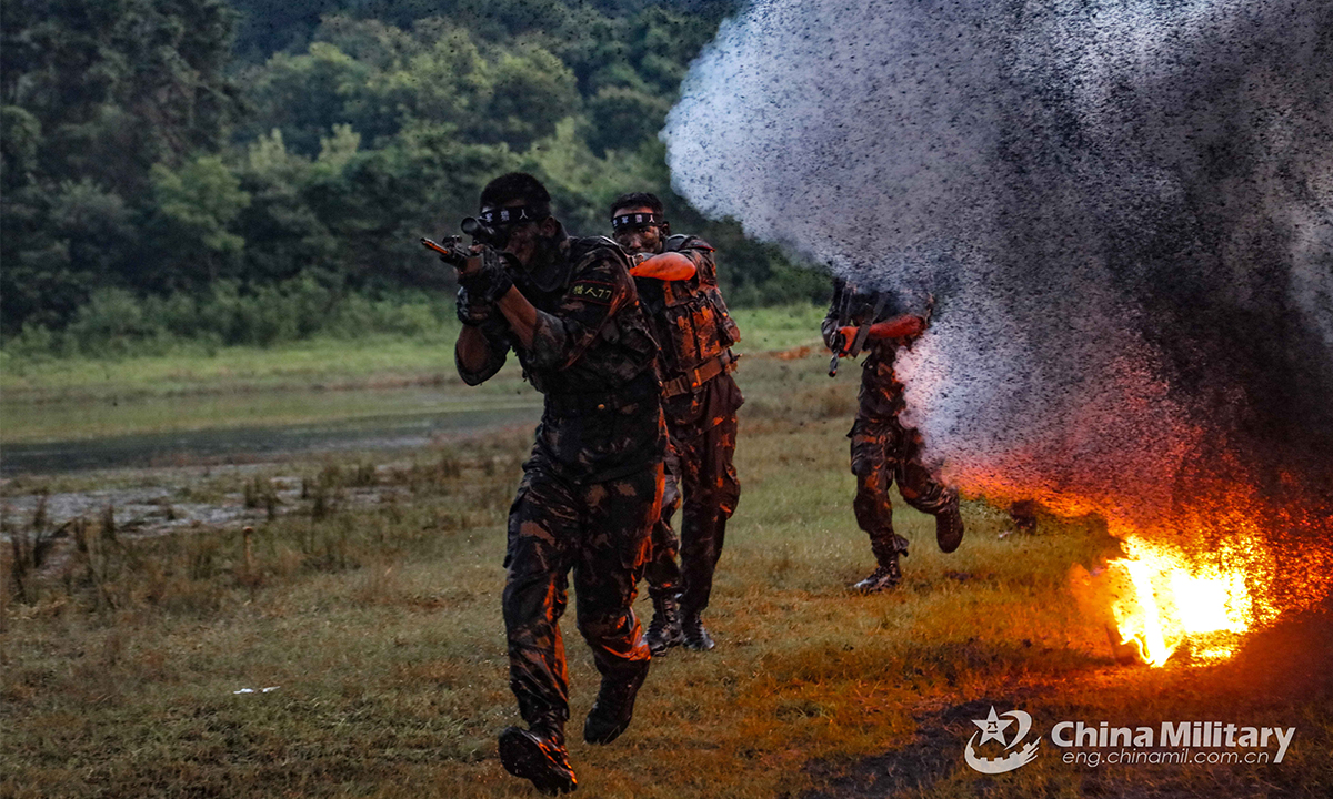 Special operations members assigned to the PLA Air Force pass through obstacles during the Hell Week extreme military training in late August. Within the week-long training courses, all the 75 participating members were required to complete 25 training subjects, including loaded march and surviving in the wild. (eng.chinamil.com.cn/Photo by Yang Haofeng)