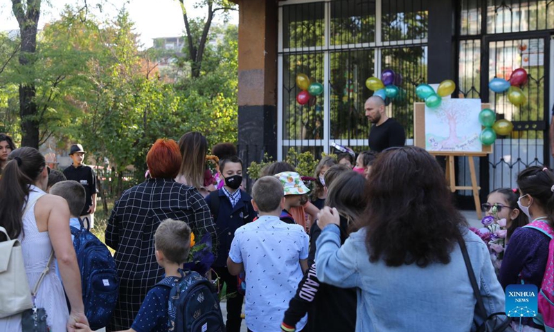 Parents watch their children entering a school in Sofia, Bulgaria, Sept. 15, 2021. Despite the severe COVID-19 pandemic in Bulgaria, all the 2,357 schools across the country opened their classrooms for the new school year.Photo: Xinhua