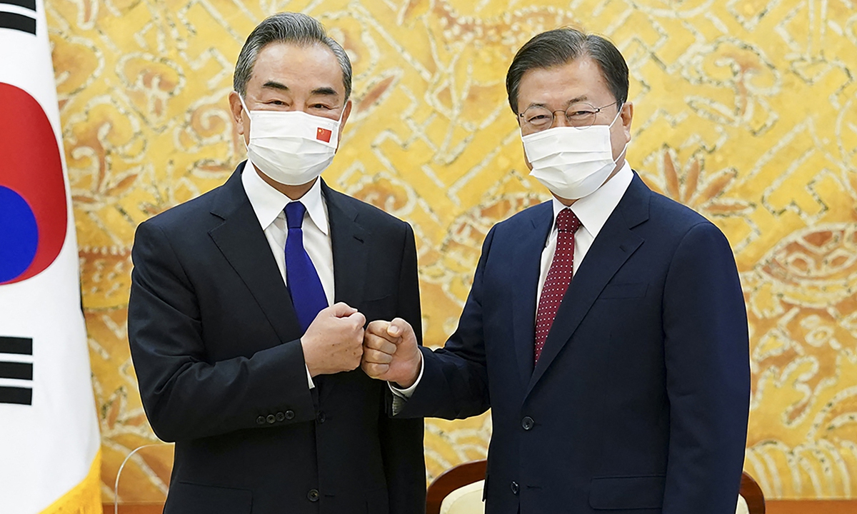 Chinese State Councilor and Foreign Minister Wang Yi (left) greets with South Korean President Moon Jae-in  during their meeting at the presidential Blue House in Seoul on Wednesday. Photo: AFP
