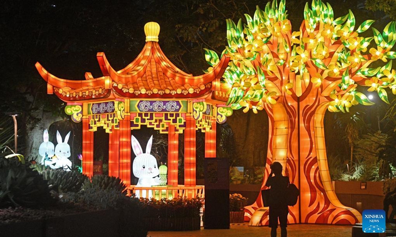 A visitor takes photos at an event to greet the coming Mid-Autumn Festival at Singapore's Gardens by the Bay on Sept. 15, 2021.(Photo: Xinhua)
