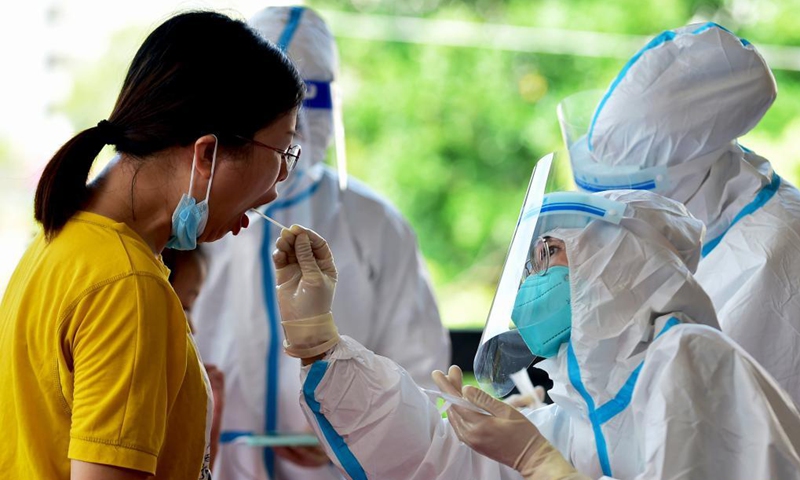 A health worker collects swab sample from a resident for nucleic acid testing in Xianyou County, Putian City, southeast China's Fujian Province, Sept. 16, 2021. Fujian reported 48 new locally-transmitted confirmed COVID-19 cases on Wednesday, the provincial health commission said Thursday.Photo:Xinhua