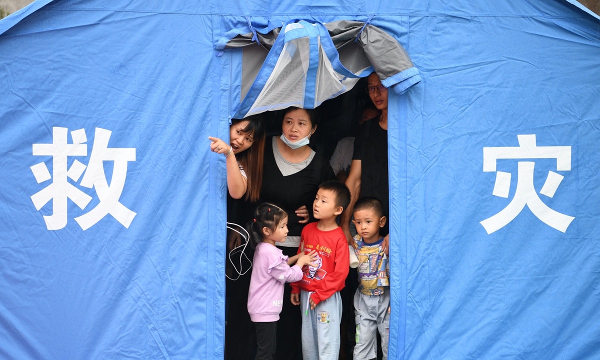 Evacuated residents wait in an emergency tent after an earthquake in Luxian county, Southwest China's Sichuan Province, on Thursday. Three people were dead and 100 others injured as of Thursday night after the 6.0-magnitude earthquake. Photo: thepaper.cn