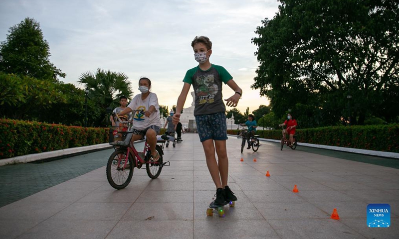 Children have fun at a downtown park before the overnight curfew imposes in Vientiane, Laos, on Sept. 12, 2021. The Lao government has extended the current nationwide lockdown to Sept. 30 to contain the spread of COVID-19.Photo: Xinhua 