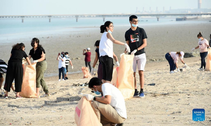 People participate in a beach cleanup campaign at a beach in Jahra Governorate, Kuwait, on Sept. 18, 2021. Kuwait marks World Cleanup Day on Saturday by organizing a coastal cleanup campaign to raise environmental awareness and shed light on threats to the environment. (Photo by Asad/Xinhua)