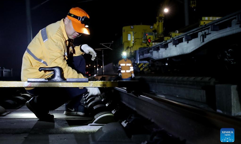 Maintenance workers change rails on the high-speed railroad linking east China's Shanghai and the city of Hangzhou in east China's Zhejiang Province, Sept. 18, 2021. (Xinhua/Fang Zhe)
