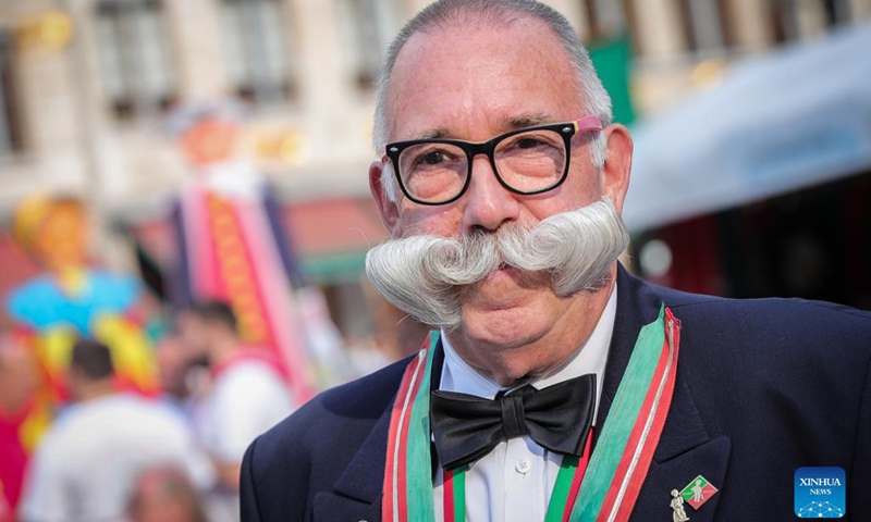 A man with a special mustache attends the Folklorissimo, or the Festival of Folklore, at the Grand-Place in Brussels, Belgium, on Sept. 18, 2021. (Xinhua/Zheng Huansong) 