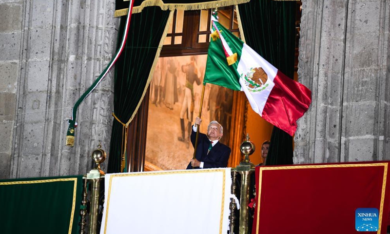 Mexican President Andres Manuel Lopez Obrador waves a Mexican flag at the National Palace during the Independence Day celebrations in Mexico City, capital of Mexico, Sept. 15, 2021.Photo:Xinhua