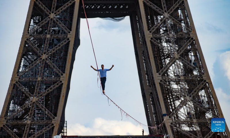 French highliner Nathan Paulin performs on a 70-meter-high slackline spanning 670 meters between the Eiffel Tower and the Theater National de Chaillot in Paris, France, on Sept. 18, 2021. (Xinhua)

