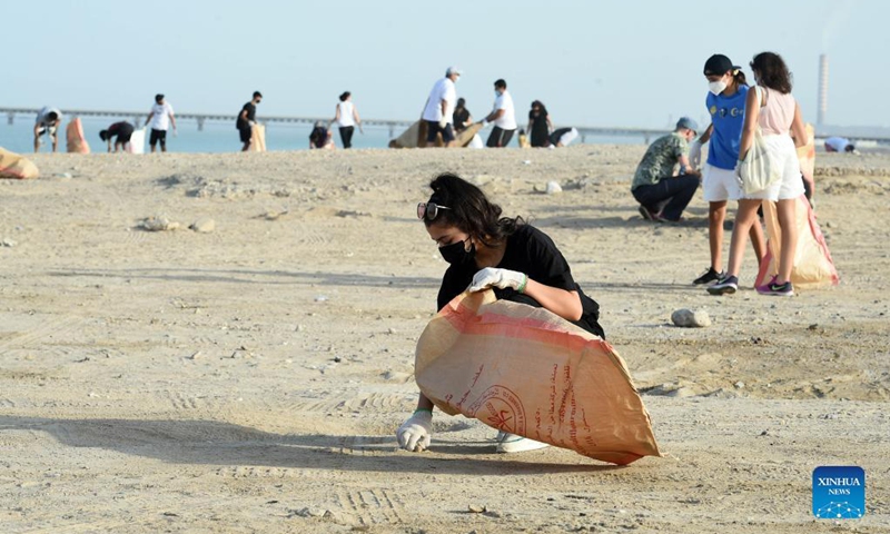 A girl participates in a beach cleanup campaign at a beach in Jahra Governorate, Kuwait, on Sept. 18, 2021. Kuwait marks World Cleanup Day on Saturday by organizing a coastal cleanup campaign to raise environmental awareness and shed light on threats to the environment. (Photo by Asad/Xinhua) 
