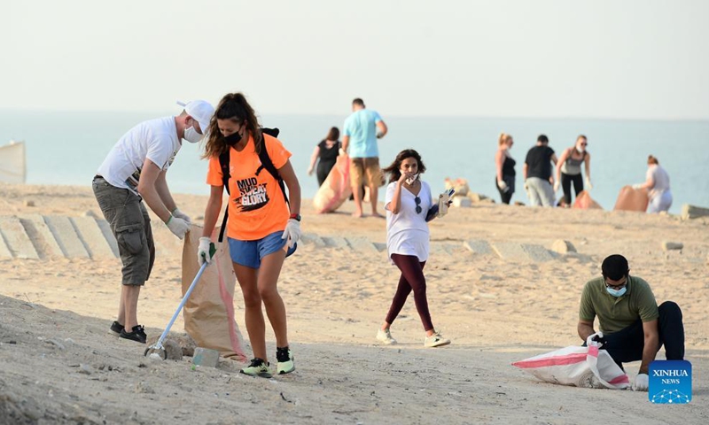 People participate in a beach cleanup campaign at a beach in Jahra Governorate, Kuwait, on Sept. 18, 2021. Kuwait marks World Cleanup Day on Saturday by organizing a coastal cleanup campaign to raise environmental awareness and shed light on threats to the environment. (Photo by Asad/Xinhua)

