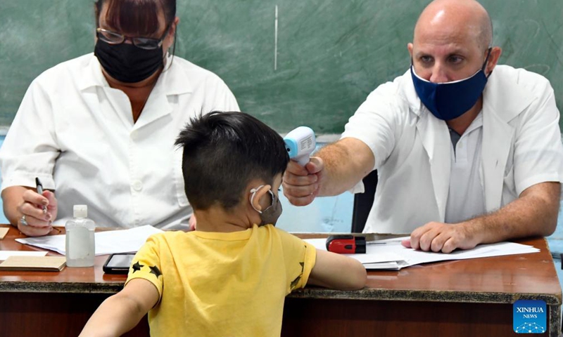 A child has his body temperature checked before getting vaccinated against COVID-19 at a school in Havana, Cuba, Sep 16, 2021.Photo:Xinhua