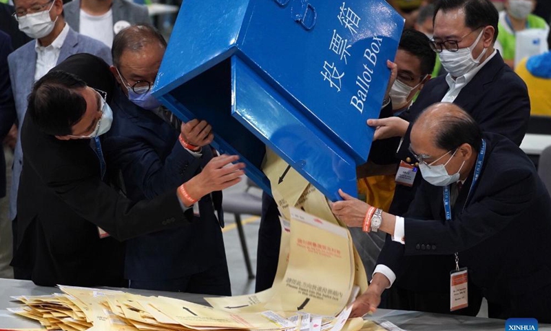 Chairman of the China's Hong Kong Special Administrative Region (HKSAR) Electoral Affairs Commission Justice Barnabas Fung Wah (2nd R) opens a ballot box at a counting station in Hong Kong, south China, Sept. 19, 2021. The voting of the 2021 Election Committee's subsector ordinary elections in China's Hong Kong Special Administrative Region (HKSAR) ran from 9:00 a.m. to 6:00 p.m. local time on Sunday. (Xinhua)
