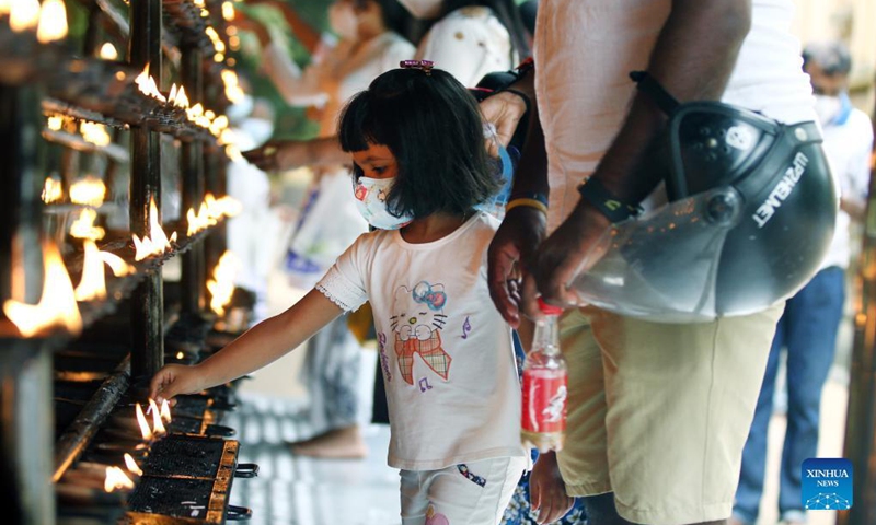 A girl offers prayers during the Poya Day in the Kelaniya Temple in Kelaniya, Sri Lanka, Sept. 20, 2021. Poya day is a monthly holiday in Sri Lanka, marking the full moon.(Photo: Xinhua)