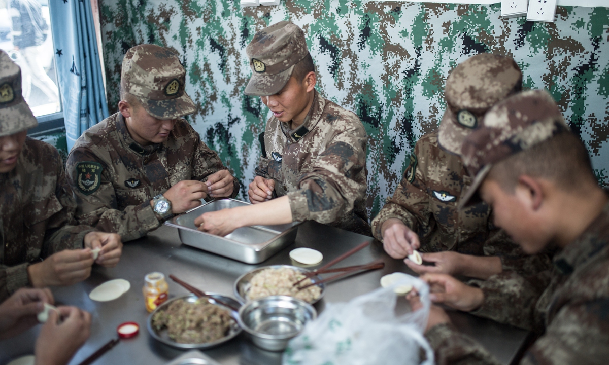 Soldiers of the third company make dumplings together before the Mid-Autumn Festival dinner on Sunday. Photo: Shan Jie